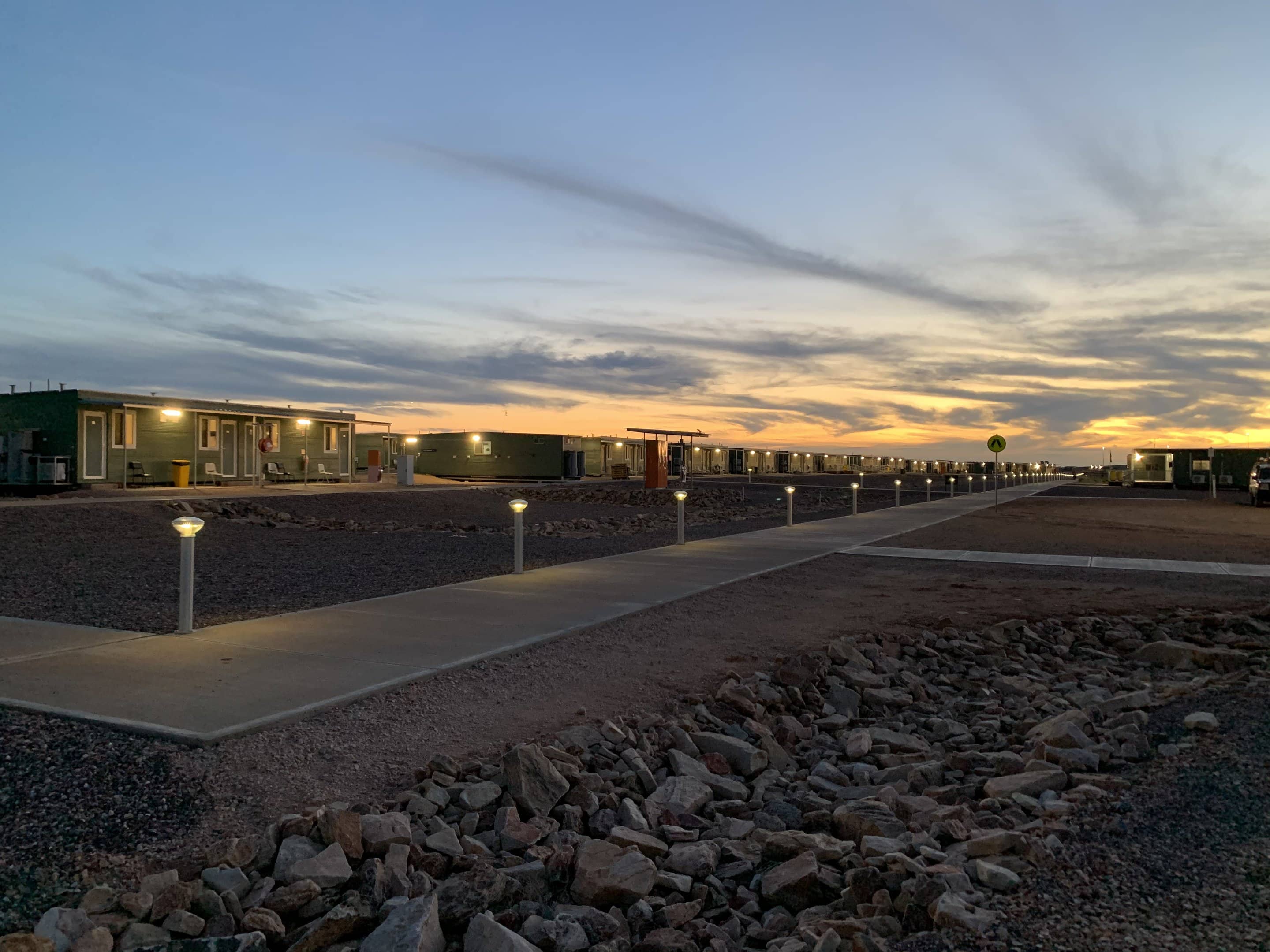 Solar bollards along a gravel access road at the Carrapateena mine camp, South Australia, at sunset