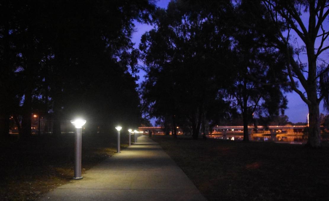An SBL2 base-plate mounted solar bollard lighting a pathway in Forbes, New South Wales, at night