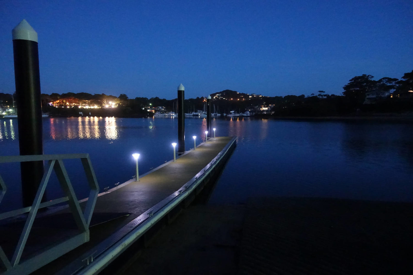 A jetty pontoon with Solar Bollard lights on it at night.