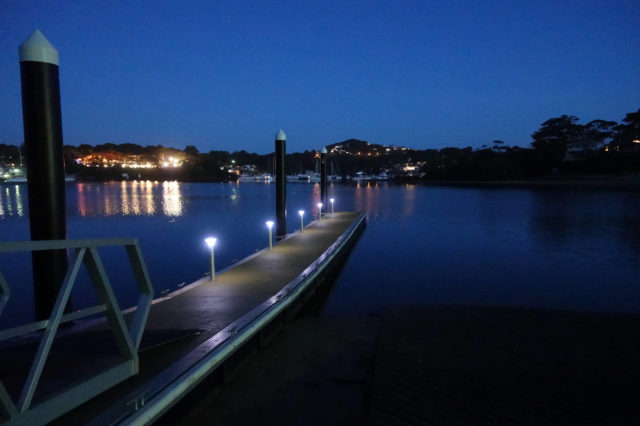 A jetty pontoon with Solar Bollard lights on it at night.